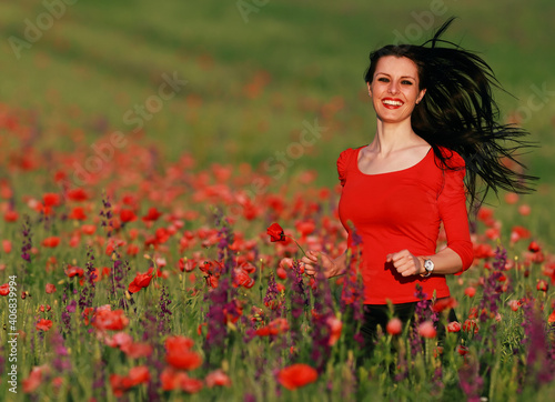 Young brunette beautiful girl enjoying the spring flowers