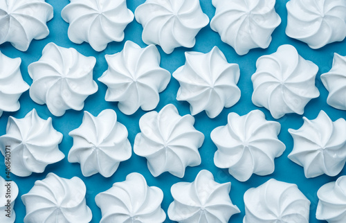 white meringues on blue background