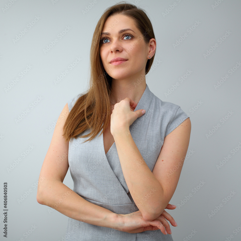 Smiling business woman in gray dress posing on gray background Smiling business woman in gray dress posing on gray background