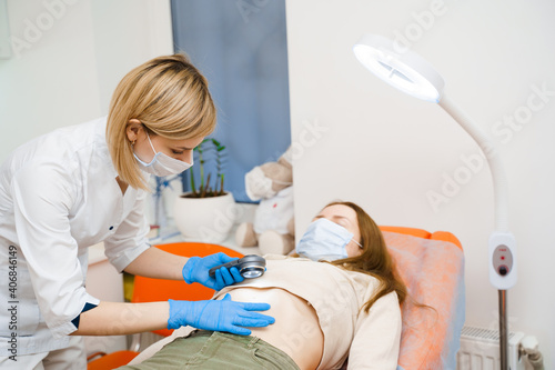 Dermatologist makes an examination using a dermatoscope. Consultation with a doctor. Rejuvenating procedure