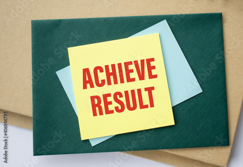 achieve results, text on yellow paper on wood background