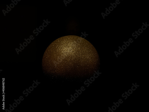 Golden shiny ball in the dark. Golden planet. Concept for designers.