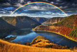 colorful rainbow over river canyon. autumn landscape