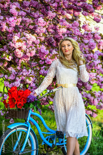 Transportation and travel. Seasonal allergy. Girl vintage cruiser bicycle near sakura tree. Woman in garden. Aroma concept. Sakura tree blooming. Sakura season. Tender fragrance. Hobby and leisure
