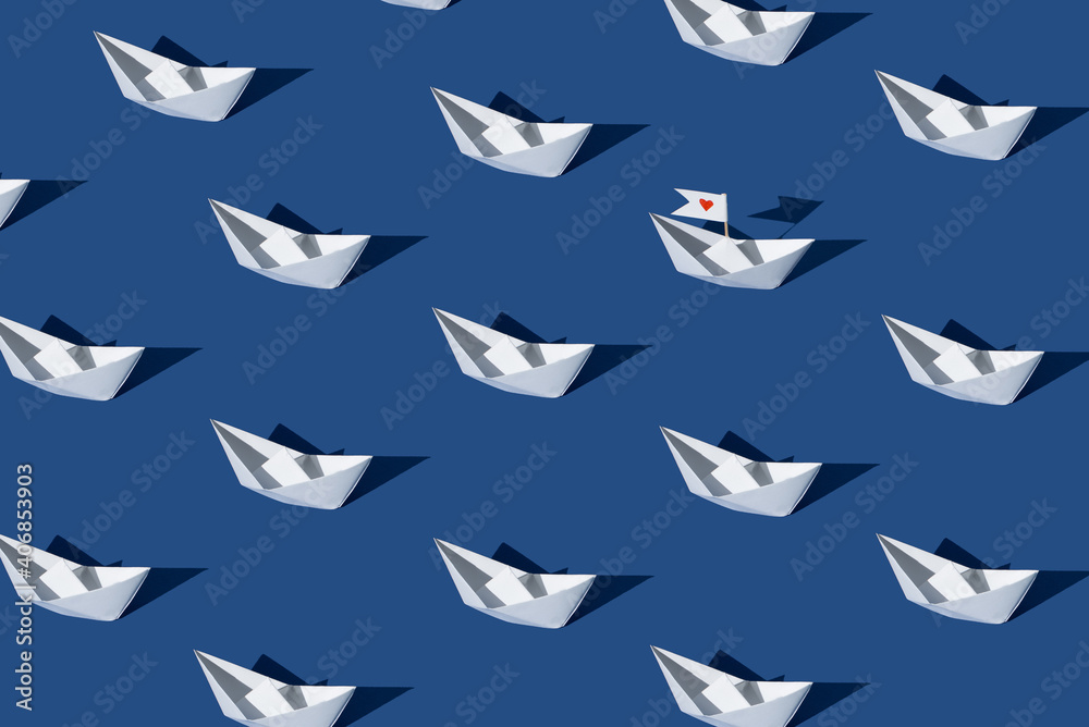 Fototapeta premium Love boat. Creative pattern made with paper boats against blue background.