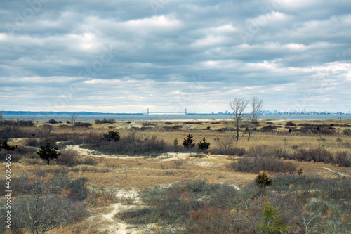 Sandy Hook, NJ - USA - Jan 17, 2021: A landscape view of the outer harbor of New York City, the Verrazzano-Narrows Bridge and the city skyline. Viewed from Sandy Hook's North Beach Observation Deck
