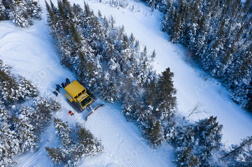 Obraz na płótnie Aerial drone photo of a group of skiers and snowboarders in a snow cat in the Chic Choc Mountains of Quebec, Canada w salonie