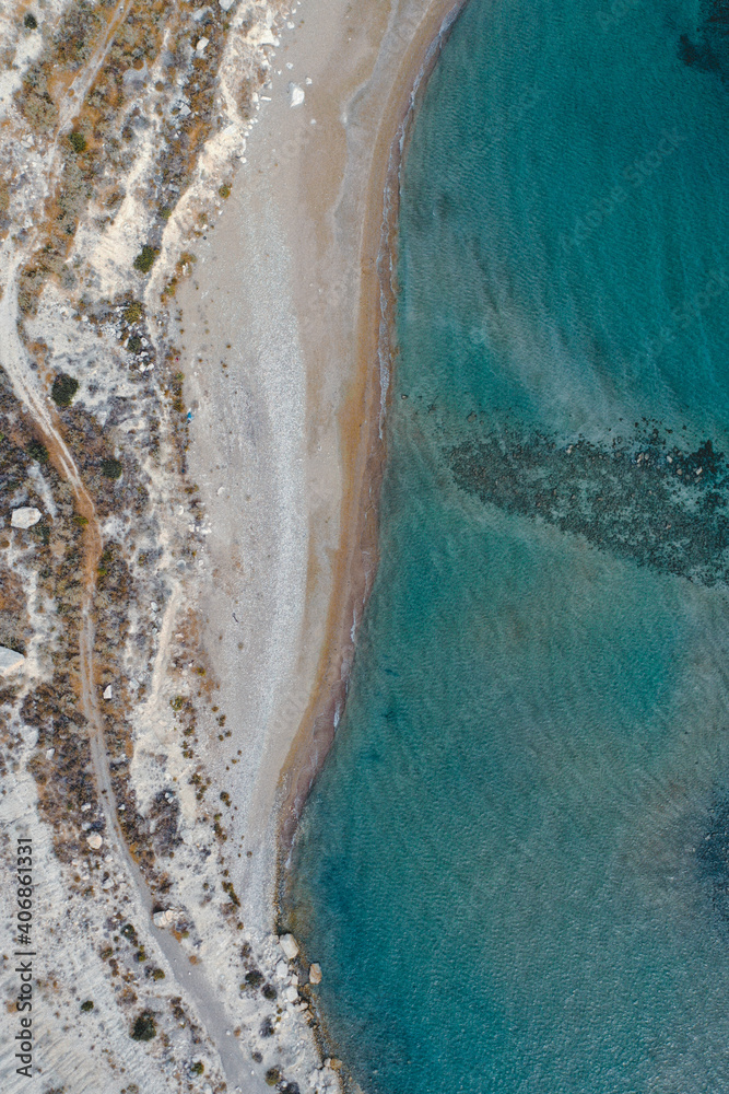 Aerial view from of the sandy beach coastline in the Mediterranean Sea.