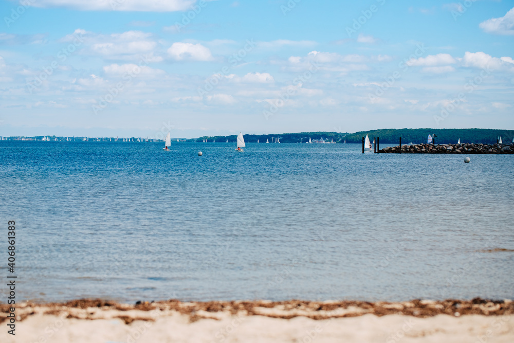 The Baltic Sea with many leash sailing ships. Big blue lake with beach. Lake in Germany