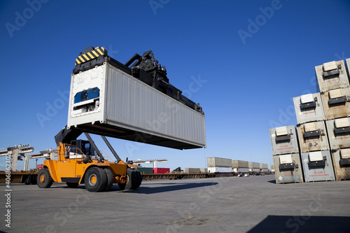 Mobile crane in train rail yard photo