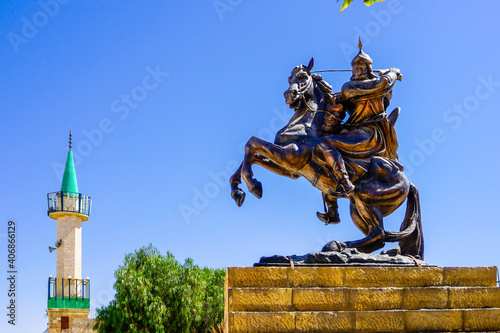 Jordan, city of Kerak, warrior statue of Sultan Saladin and a mosque minaret  photo