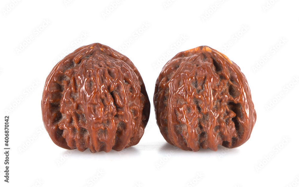 A pair of walnuts on a white background A pair of walnuts on a white background