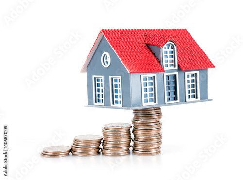 Dollar coin and small house model on white background