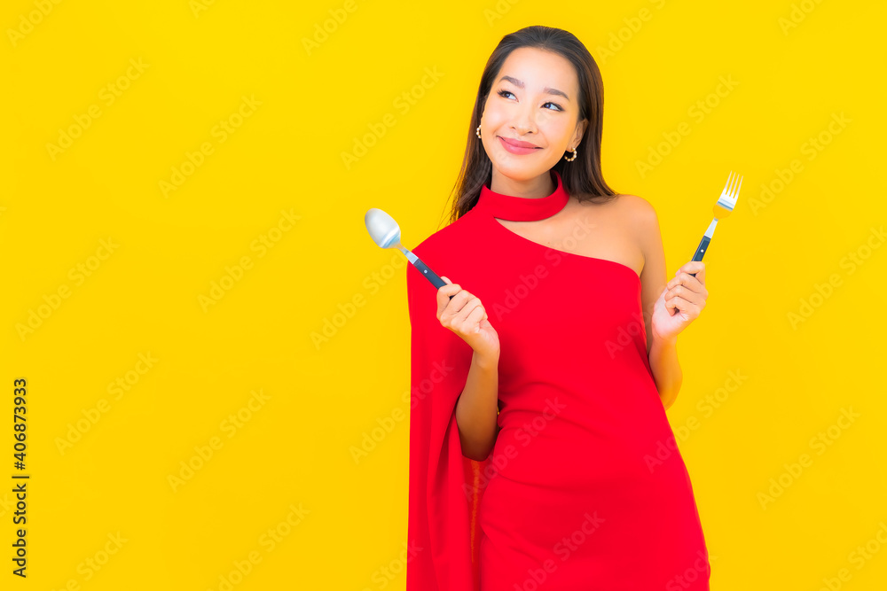 Portrait beautiful young asian woman with spoon and fork ready to eat Portrait beautiful young asian woman with spoon and fork ready to eat