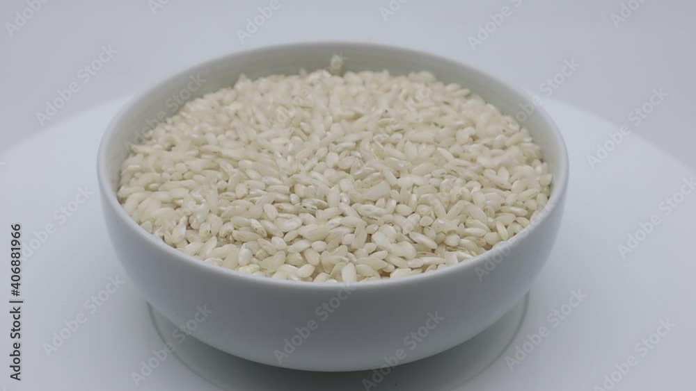 Uncooked rice in a bowl on rotating display. Uncooked rice in a bowl on rotating display.