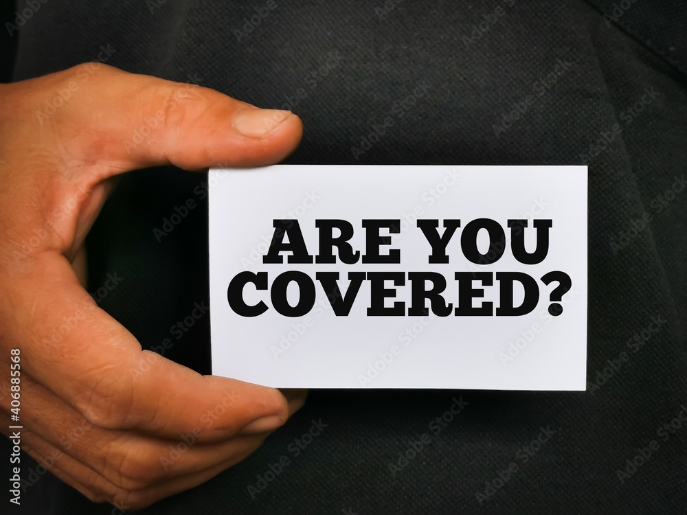Hand holding white card with text ARE YOU COVERED.Business insurance concept. Hand holding white card with text ARE YOU COVERED.Business insurance concept.