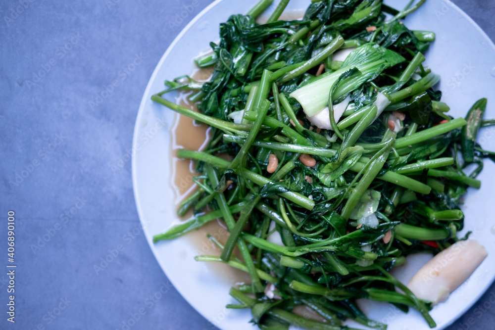 Stir fried morning glory with garlic and fresh peppers. Stir fried morning glory with garlic and fresh peppers.