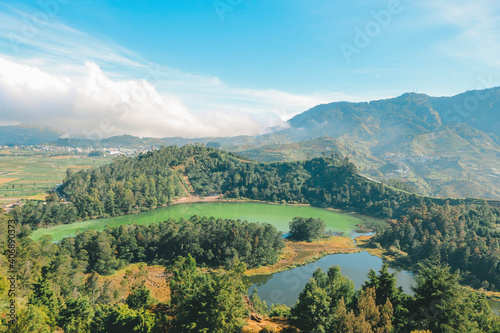 Morning view of Telaga Warna Lake with mountain background at Dieng Plateau, Central Java, Indonesia. Aerial View from Batu Pandang Ratapan Angin Hill