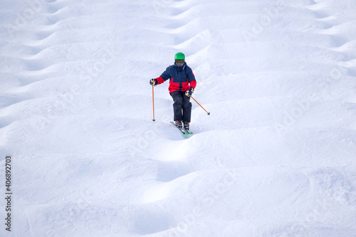 People are enjoying mogul skiing and snow boarding 