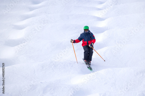 People are enjoying mogul skiing and snow boarding 