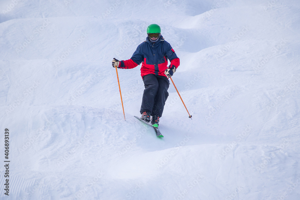 People are enjoying mogul skiing and snow boarding	