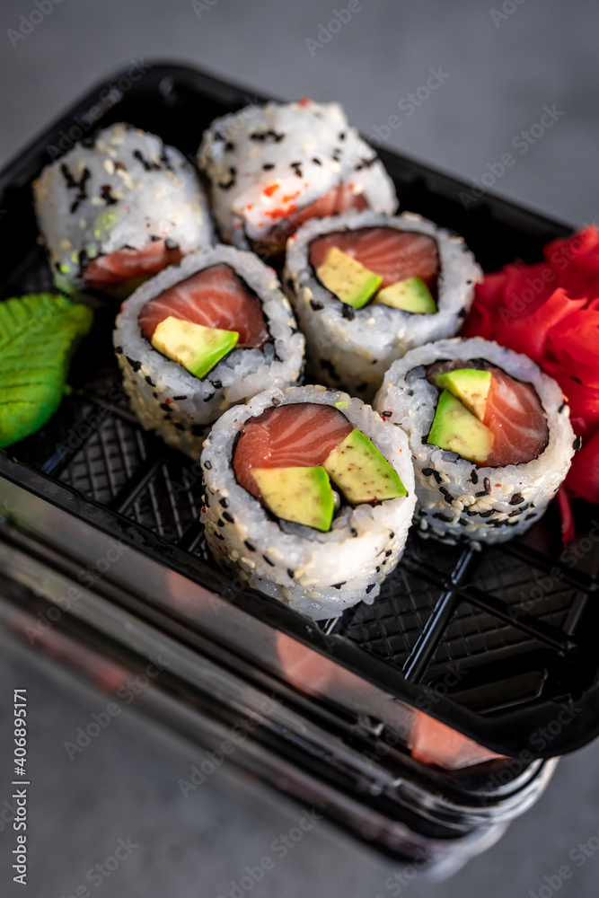Japanese food delivery. Rolls with salmon and avocado in box Japanese food delivery. Rolls with salmon and avocado in box