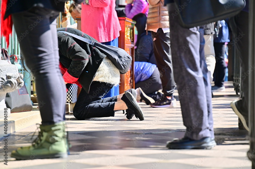 Longshan Temple, Taipei, Taiwan - January 15, 2021: the worshipper kneeling on the floor and praying.