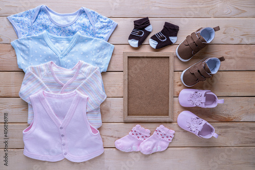 The clothes for kids for babies set with accessories on the wooden table.