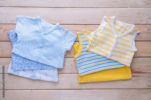 The clothes for kids for babies set on the wooden table.