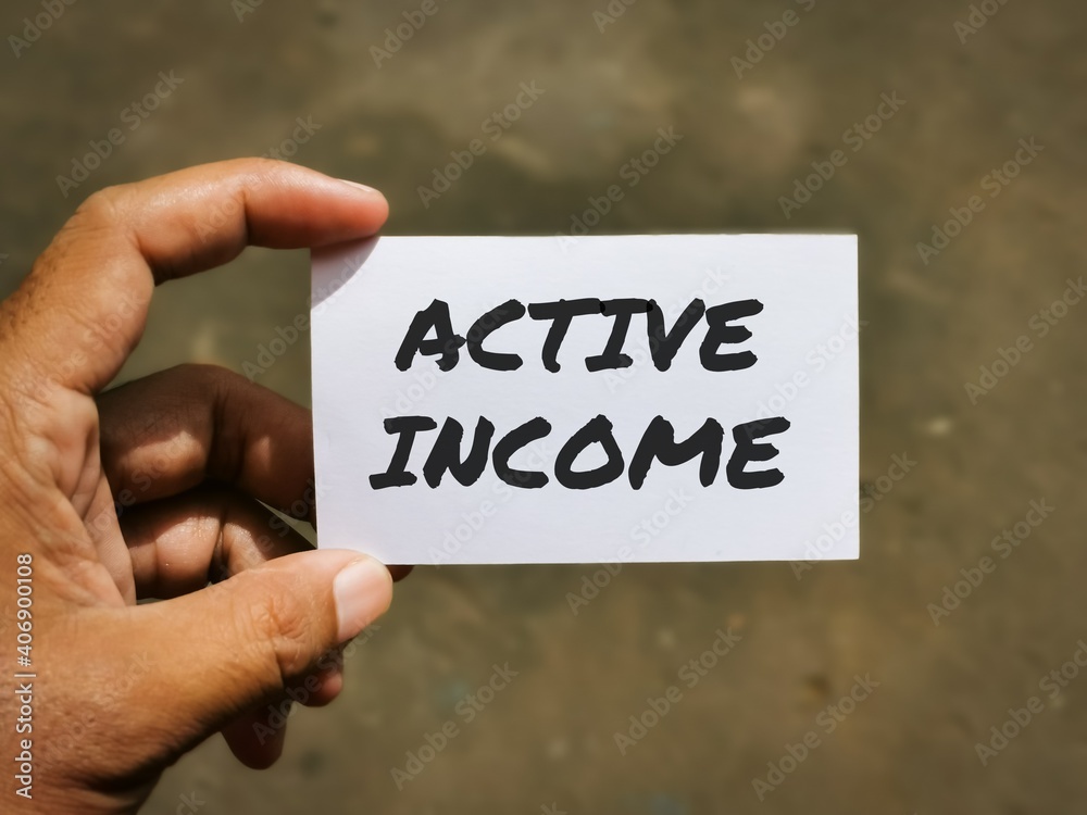 Selective focus image with noise effect hand holding white card with text ACTIVE INCOME.Business concept.