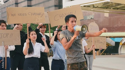 Group of asian protester against government corruption. Raise banner to show purpose from people in the city.