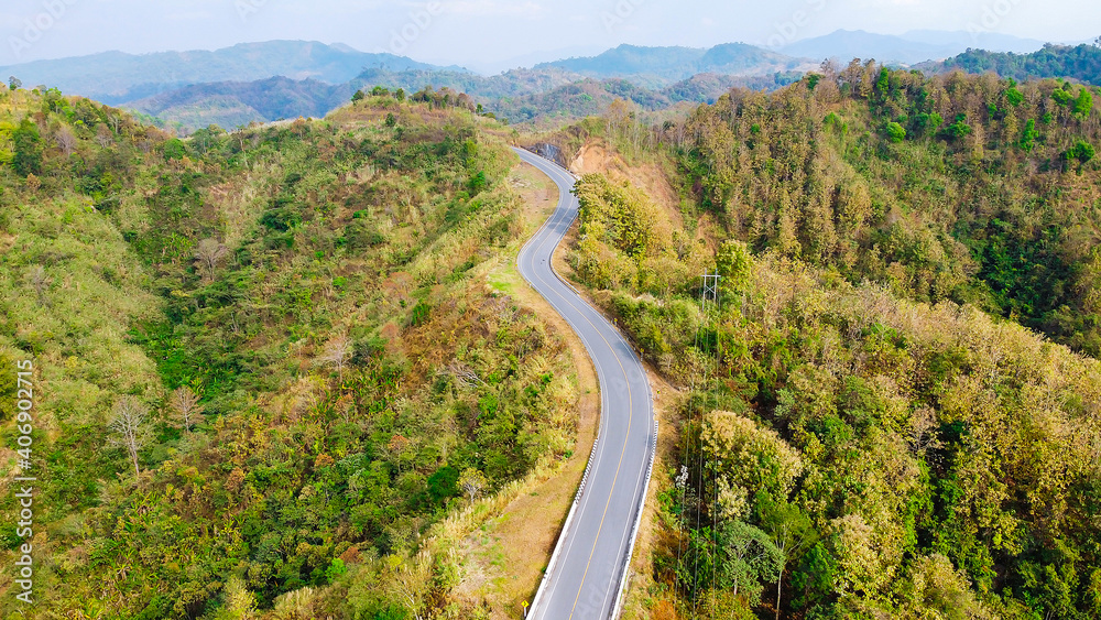 Aerial view photo curve way of asphalt road through in mountain.