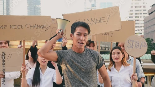 Group of asian protester against government corruption. Raise banner to show purpose from people in the city.
