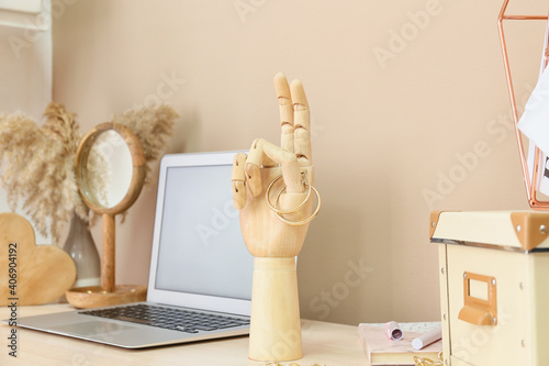 Wooden hand with laptop and...