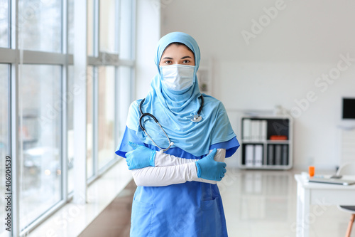 Portrait of female Muslim doctor wearing protective mask in clinic