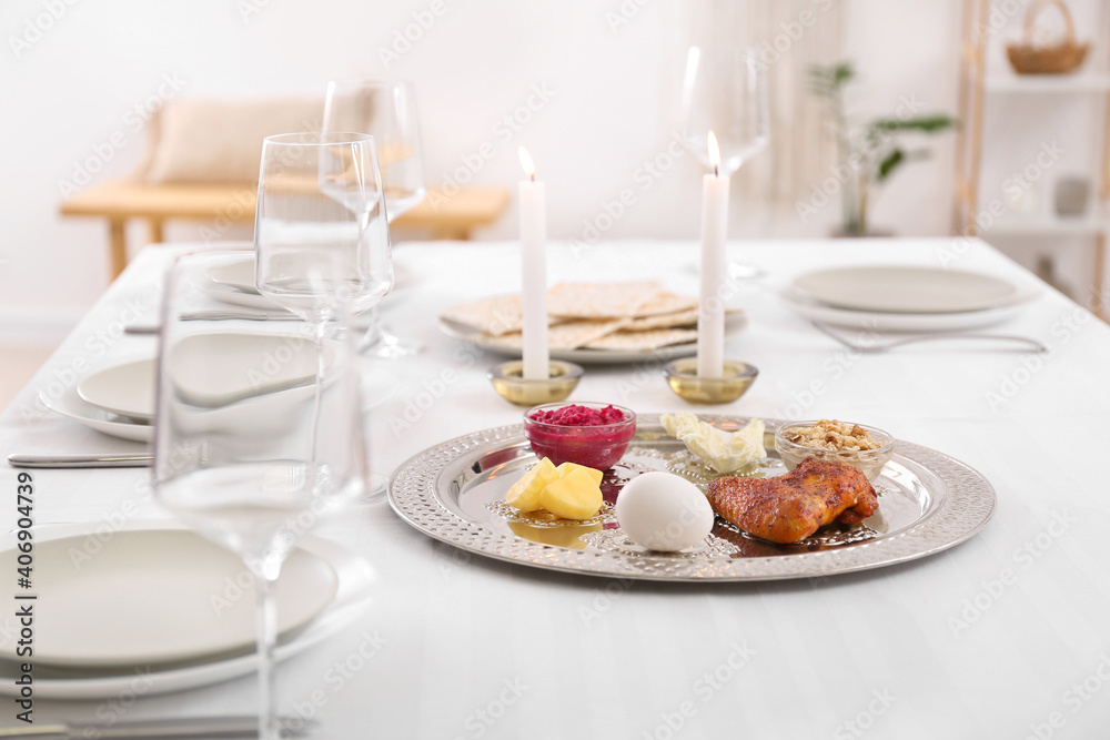 Passover Seder plate with traditional food on served table Passover Seder plate with traditional food on served table