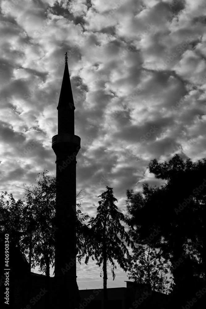 old minaret and cloudy sky