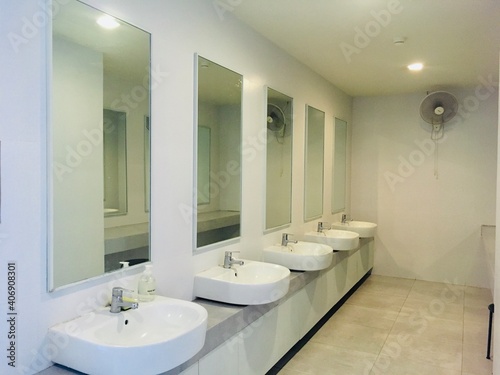 Interior basic of public restroom have classic washbowl and white clean design