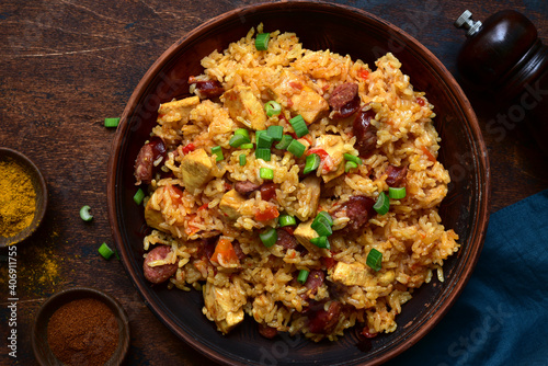 Jambalaya - spicy rice with tomatoes, meat and smoked sausage. Top view with copy space.