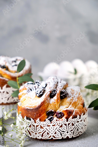 Easter cake kraffin. Craffins with raisins, candied fruits and sprinkled with powdered sugar. Close-up of homemade pie. Cruffin. photo