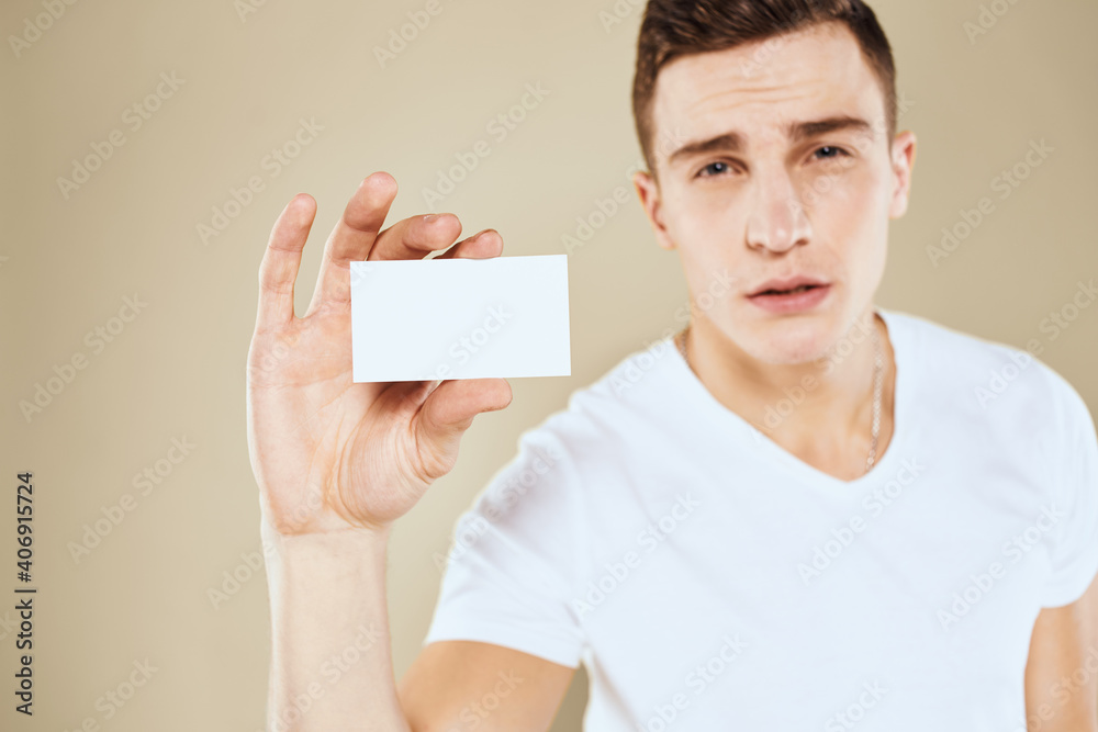 Man with a business card in the hands of an office manager beige background Copy Space Man with a business card in the hands of an office manager beige background Copy Space