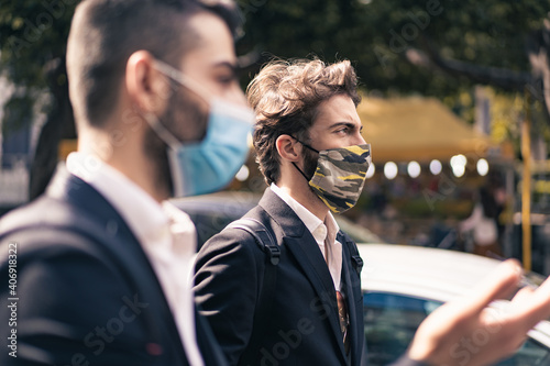 Profile portrait of young people in suit with face masks