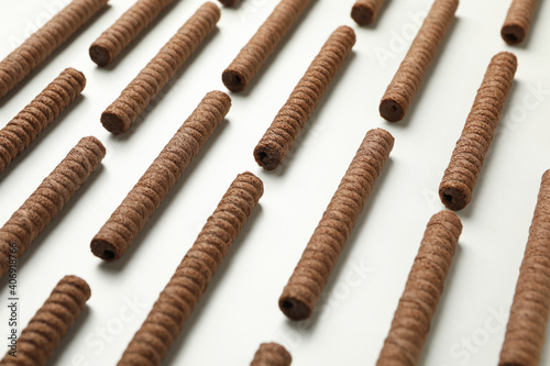 Flat lay with chocolate wafer rolls on white background