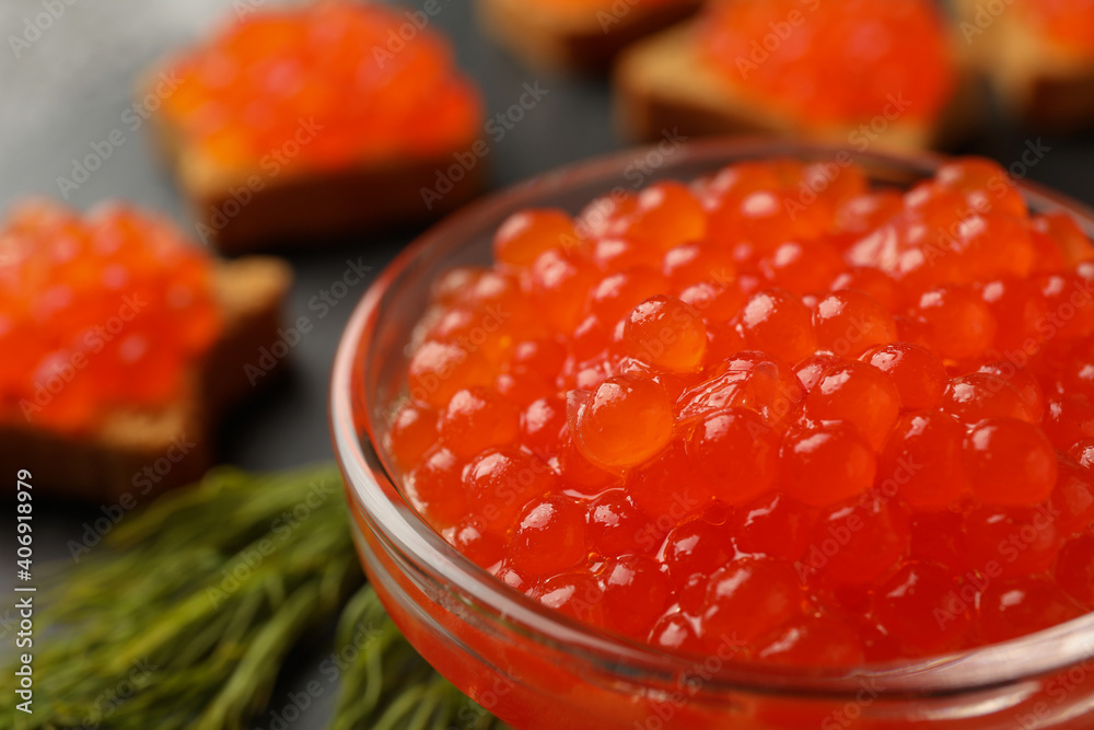 Bowl and snacks with fresh red caviar, close up Bowl and snacks with fresh red caviar, close up