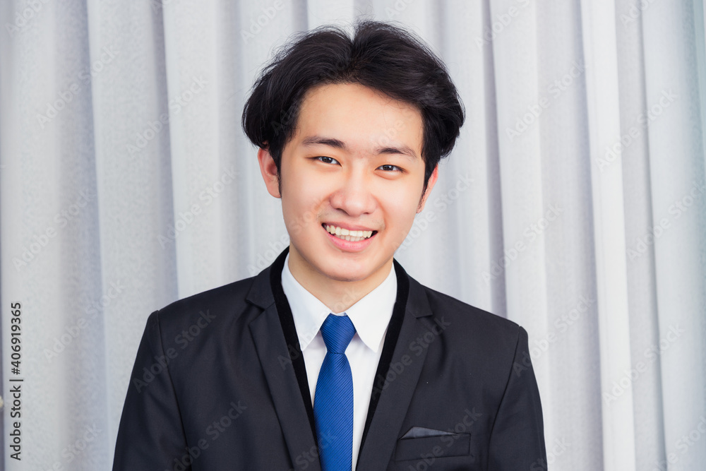 Portrait closeup of happy Asian young handsome manager professional business man laughing confident mature standing in suit smiling looking to camera with copy space Portrait closeup of happy Asian young handsome manager professional business man laughing confident mature standing in suit smiling looking to camera with copy space