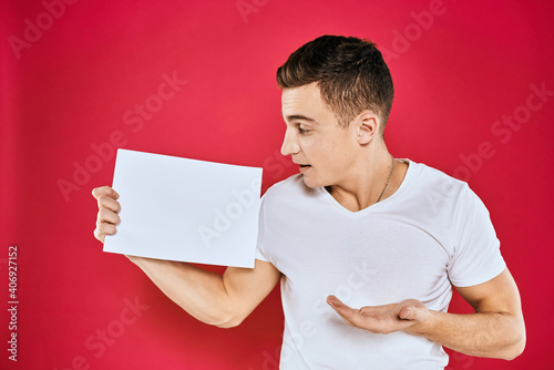 man holding white sheet copy space office close-up red background