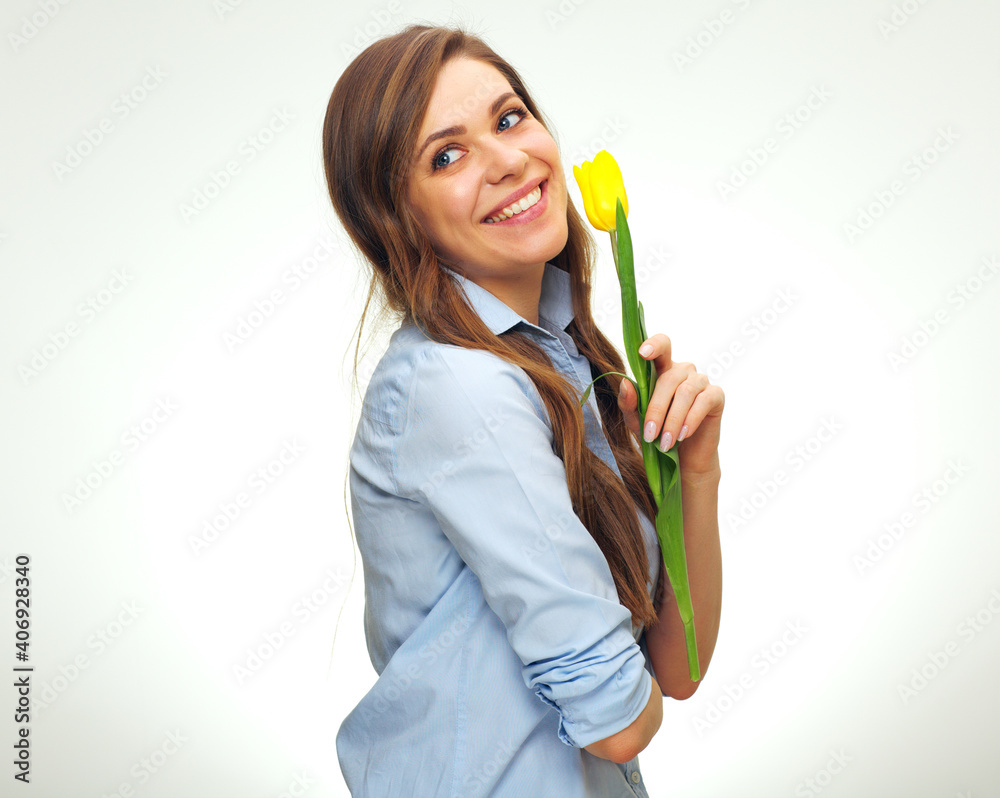 Smiling girl holding one yellow tulip flower.