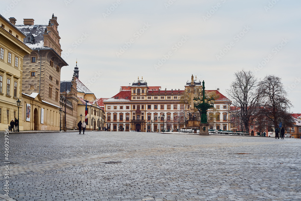 Prague, Czech Republic - January 7 2021: Empty Hradčanské square in front of Prague Castle is surrounded by Schwarzenberg and Arcibishop palaces                  