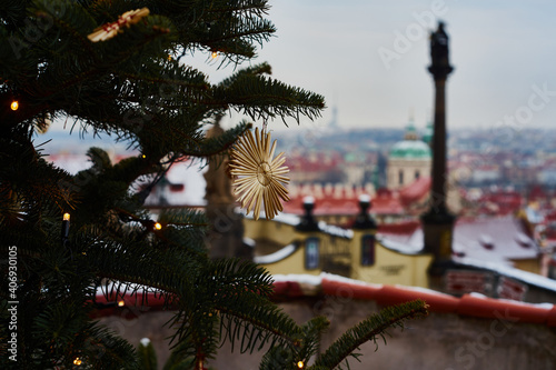 Close up of christmas tree decoration with Prague historical centre in background                               © jindrich