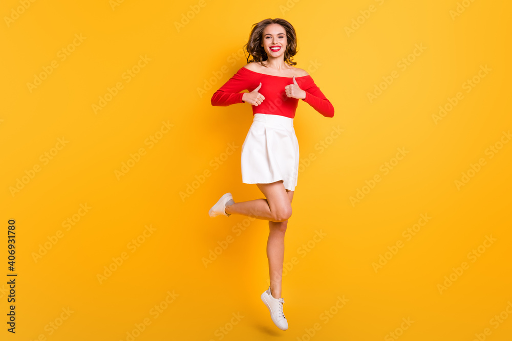 Full length body size photo girl wearing stylish outfit laughing showing like gesture both hands isolated on vibrant yellow color background